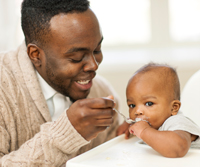 Father feeding his newborn