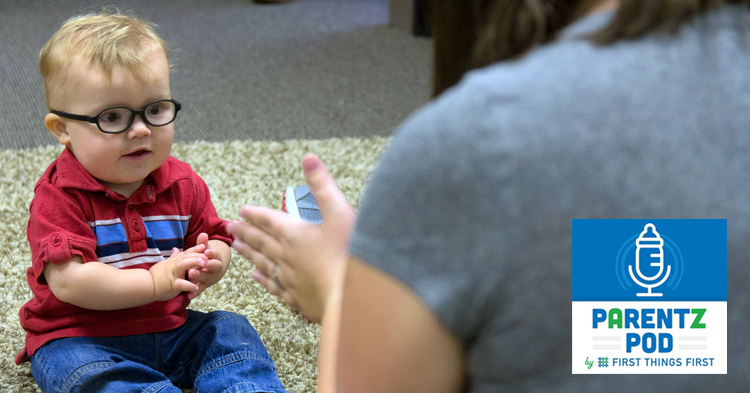 Young child with glasses plays with parents