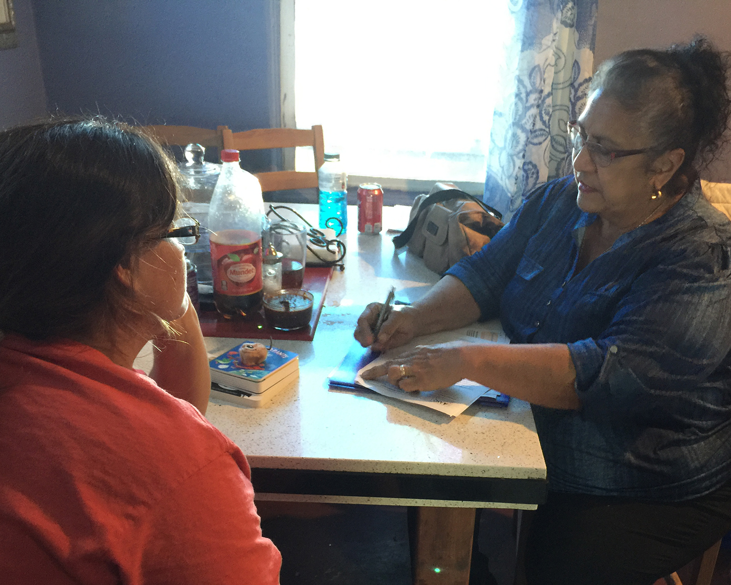 educator walking mother through two parenting booklets