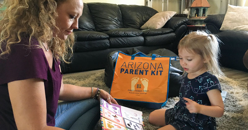 Mom reading book with toddler
