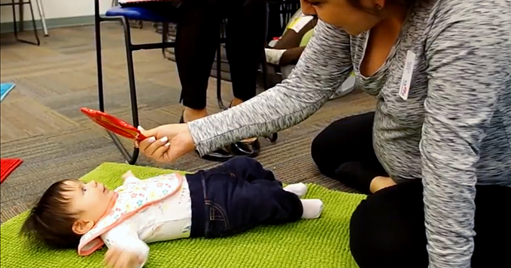 Mom and baby play with mirror