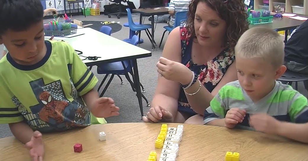 teacher working with two small boys