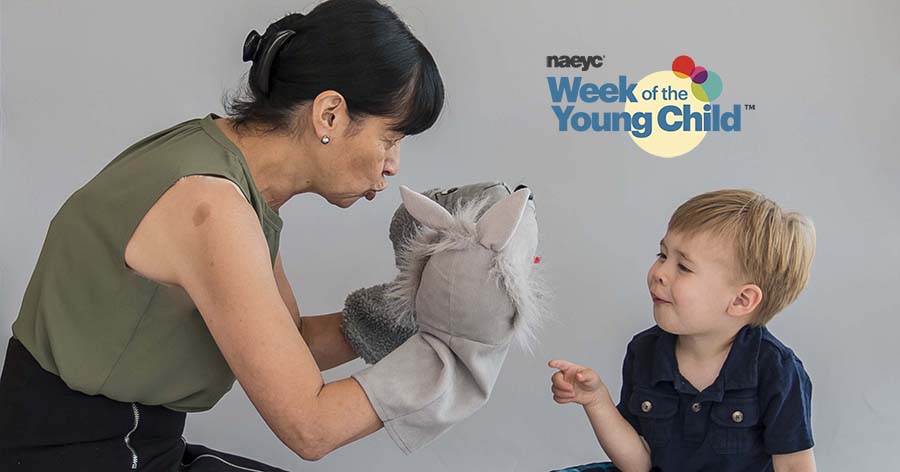 grandmother with puppet playing with grandson