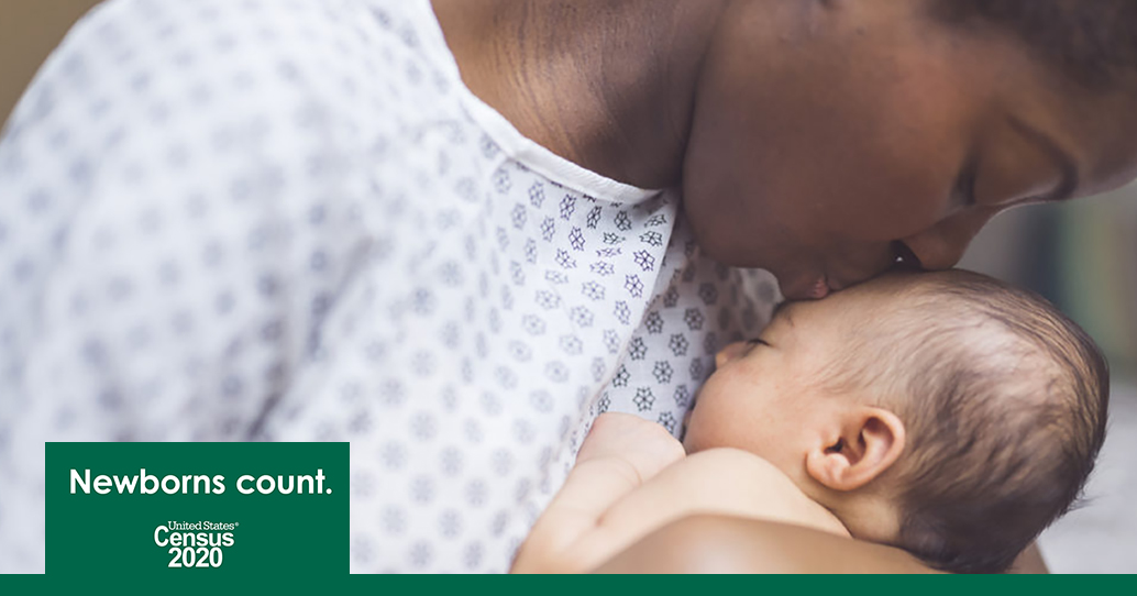 Mom kissing newborn child on forehead