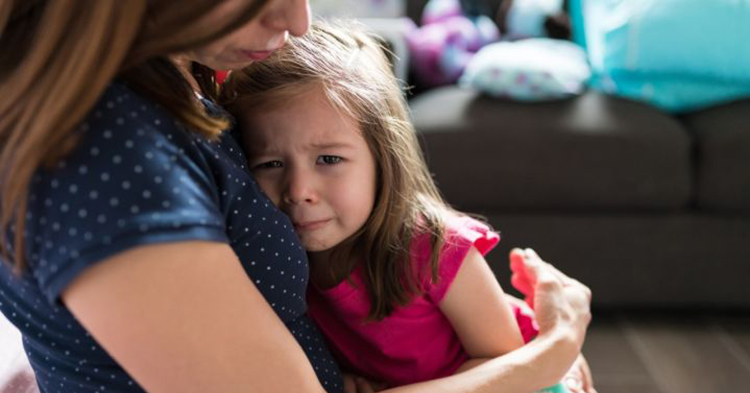 mother consoling upset daughter