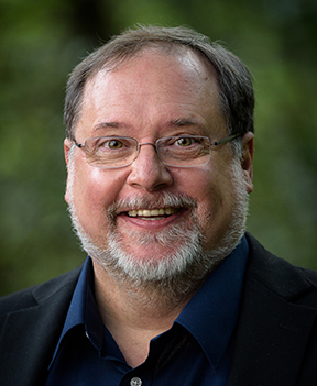 Man with blue button shirt and glasses