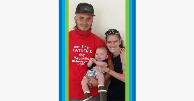 Father in baseball cap with son and his mother