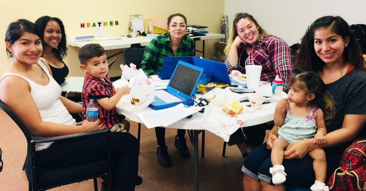 women sitting around a table doing college course work