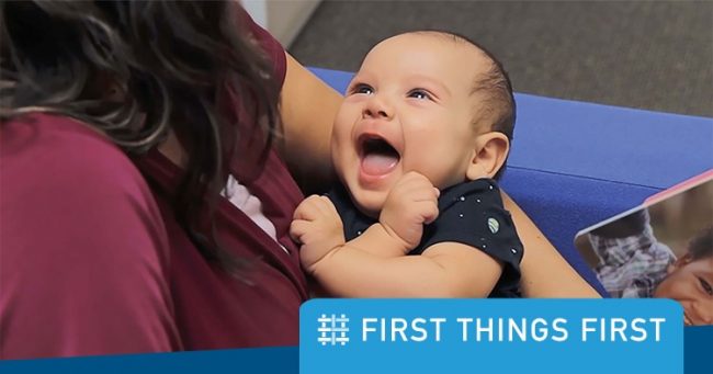 Woman holding smiling baby