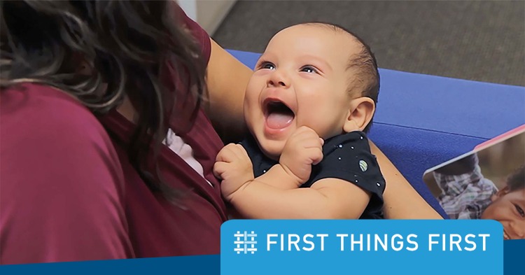 Woman holding smiling baby