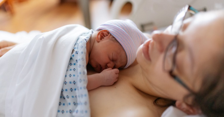 woman holding newborn baby