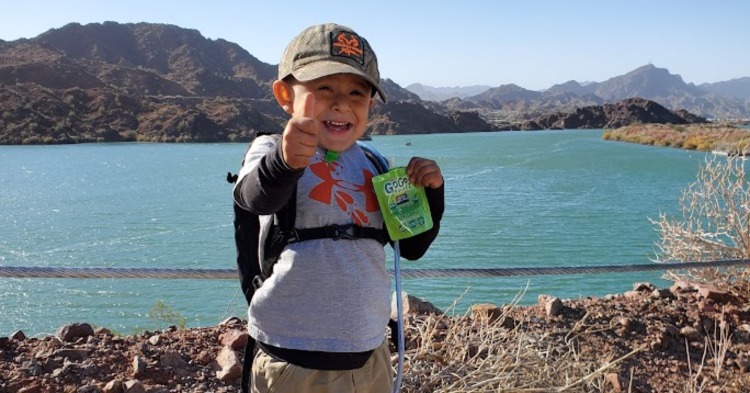 Nutrition Obesity and Physical Activity, preschooler posing in front of a lake holding a snack