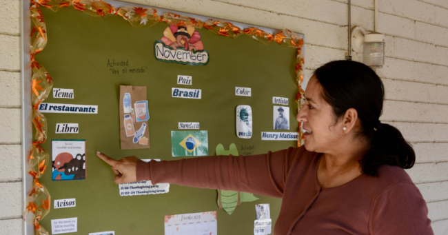 Teacher at Little Giants Spanish Immersion Preschool in Phoenix points to board featuring Spanish words. Lose access to Quality First 