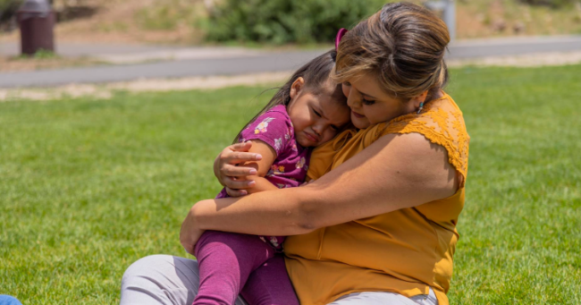 Mom comforting upset daughter with a hug