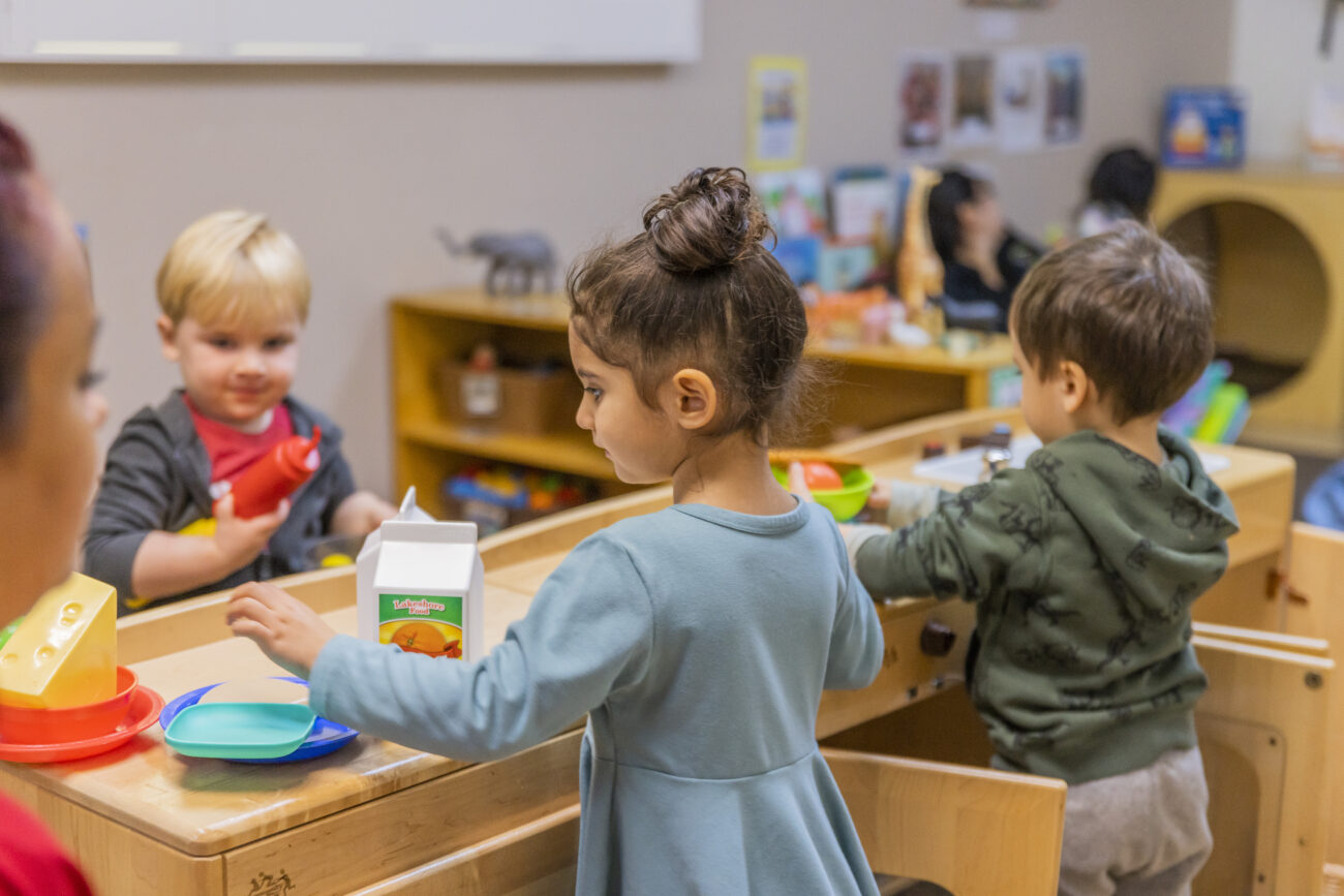 Young children learn and engage together in a child care setting.