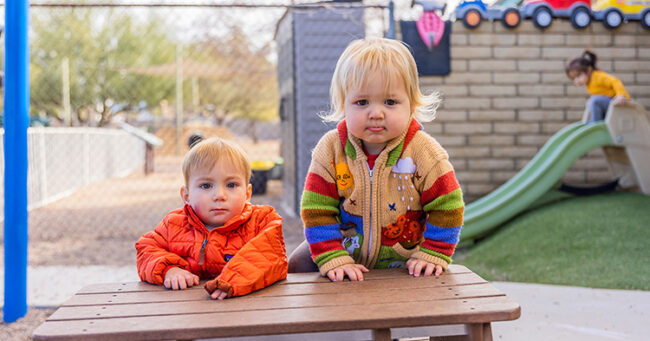 two toddler looking into camera
